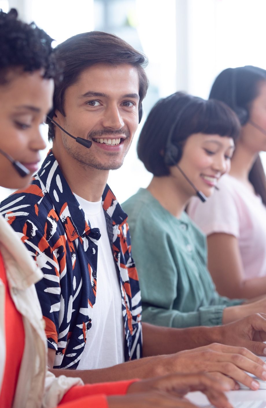 Side view of Caucasian male customer service executive working on computer at desk in office